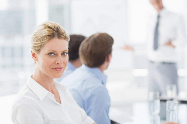 istock Businesswoman smiling at camera during a meeting 835841618