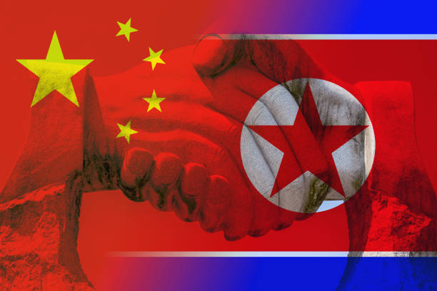 istock Friendship between China and North Korea with handshake 835841922