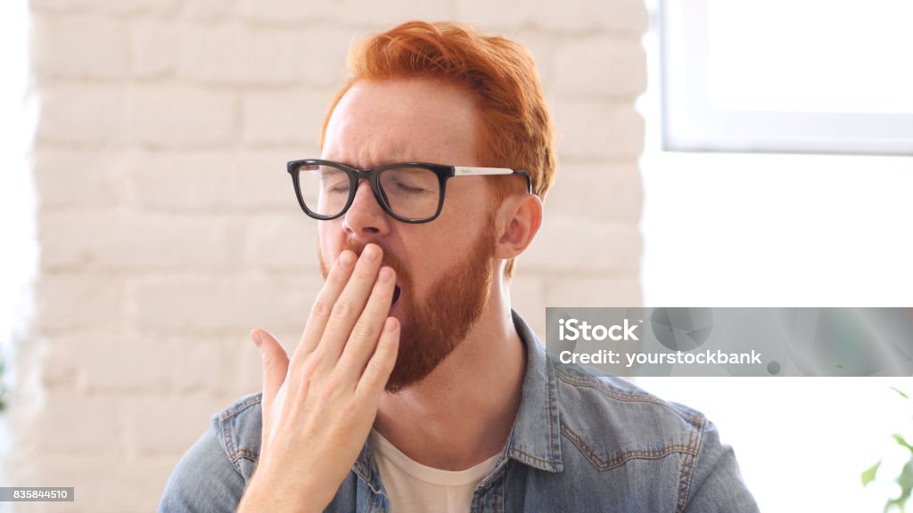 Tired Yawning Man with Beard and Red Hairs, Portrait Acting - Performance Stock Photo