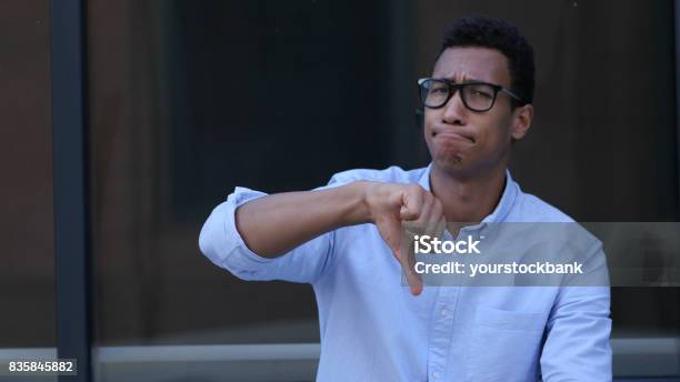 Gesture Of Unsatisfaction Thumbs Down By Young Black Handsome Man Stock Photo - Download Image Now