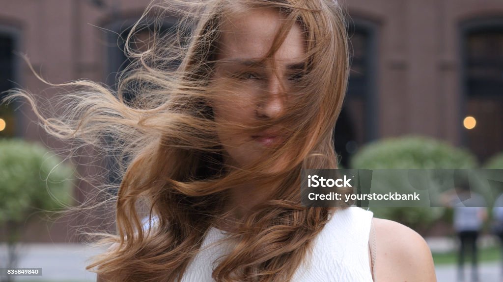 Flying Hairs in Wind of Beautiful young Girl, Outdoor Human Face Stock Photo