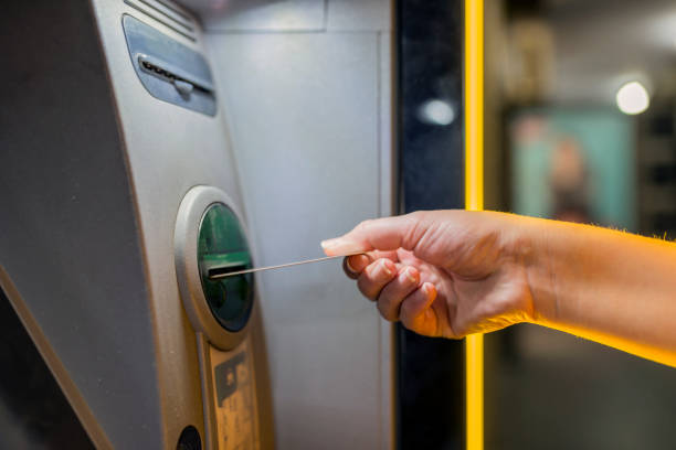 istock ATM Machine,  Woman's Hand  and credit card at night 835852776