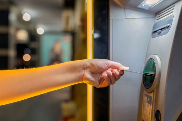 istock Woman's Hand Using Card To Withdraw Money at night 835852832