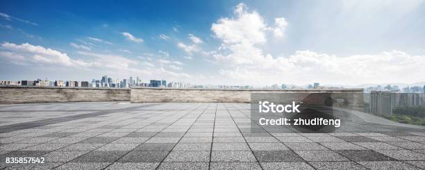 Empty Floor And Cityscape Of Modern City Against Cloud Sky Stock Photo - Download Image Now