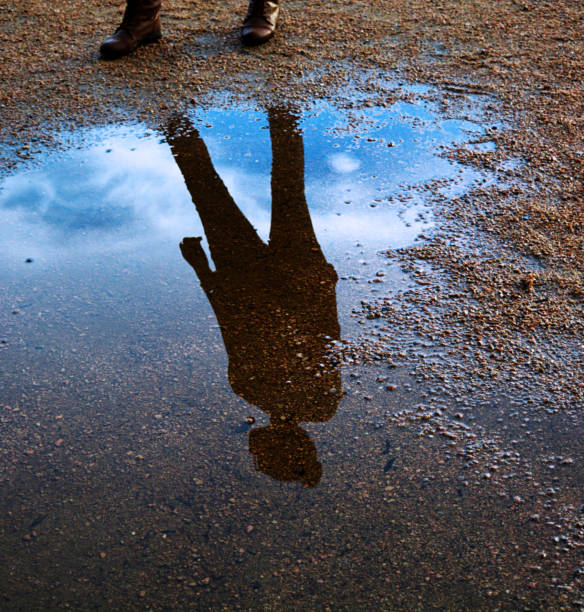 istock Water reflection of a persons silhouette with the vibrant sky 835861112