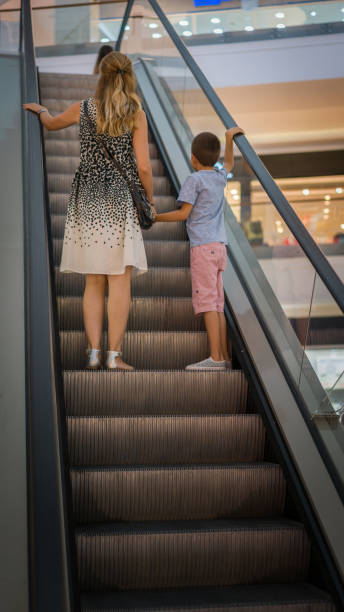 istock Mom and son on escalator 835870674