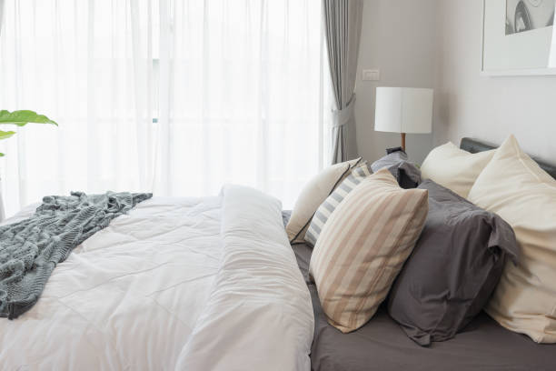 istock white blanket with set of pillows on bed 835871590