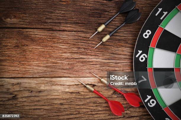 Red Dart Arrow Hitting In The Target Center Of Dartboard Stock Photo - Download Image Now