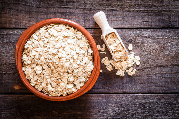 istock Brown bowl filled with oat flakes shot from above on rustic wooden table 835874800