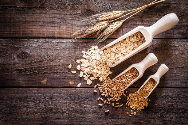 istock Oat flakes, spelt and flax seeds on rustic wooden table 835875256