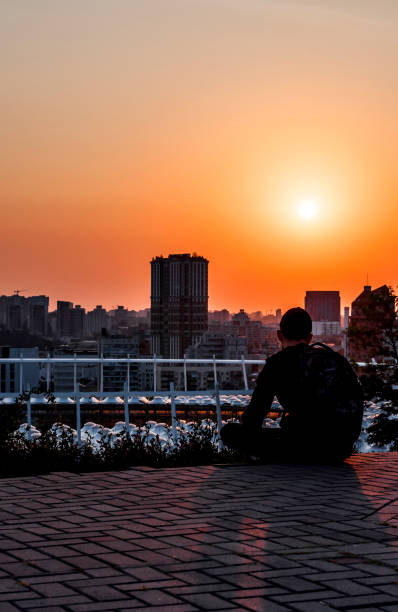 istock Silhouette of a young man on sunset background 835875260