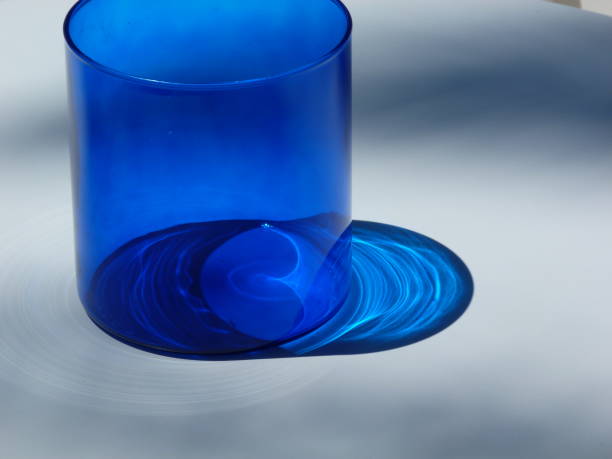 istock Blue glass and shadow on a white table, Cascais, Portugal 835875316