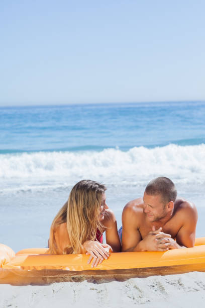 istock Cheerful cute couple in swimsuit relaxing together 835876220
