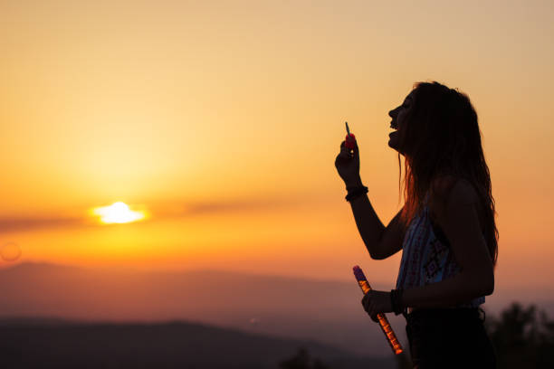istock Young beautiful girl blowing bubbles 835879562