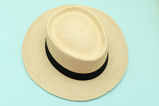 Panama-style caps (panama hat) lay on a blue sky color background, which is a popular hat for summer wear. protected sunlight.