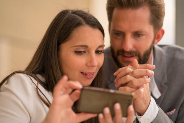 istock couple with smartphone sitting on dinner table 835881836