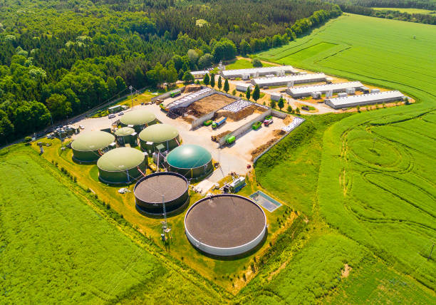 istock Biogas plant and farm in green fields. 835882022
