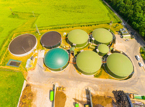 istock Biogas plant and farm in green fields. 835882218