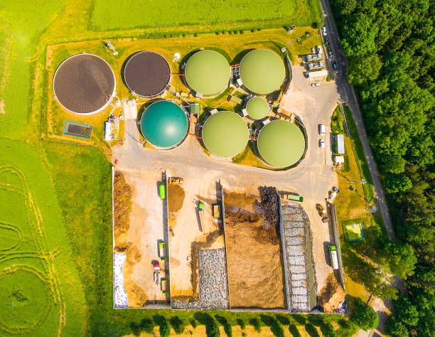 istock Biogas plant and farm in green fields. 835882226