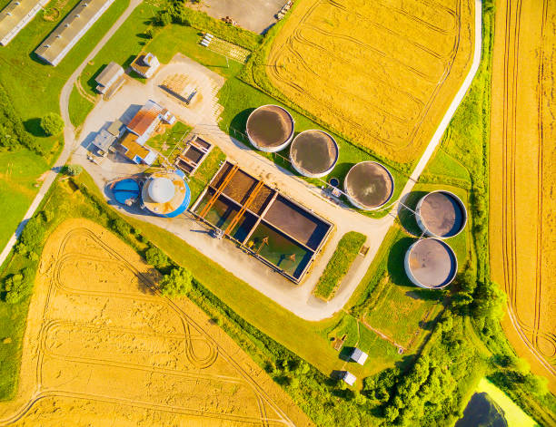 istock Biogas plant and farm in green fields. 835882414