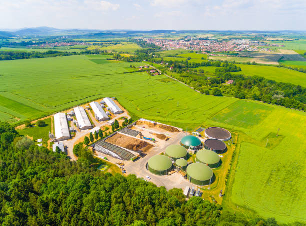 istock Biogas plant and farm in green fields. 835882548