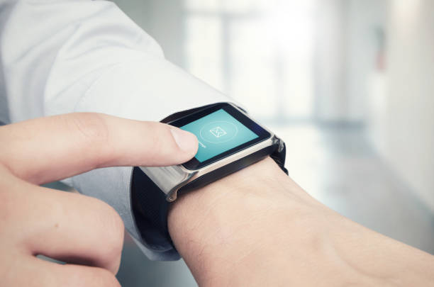 istock Businessman checking e-mail on smart watch. Office in background 835885124