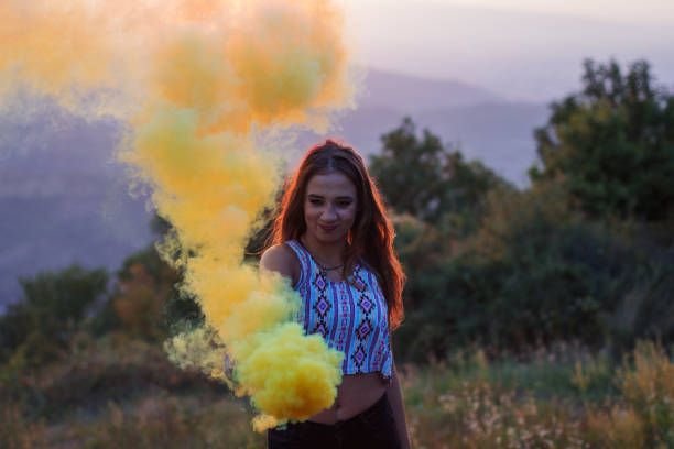 istock Girl in a yellow smoke cloud 835886280