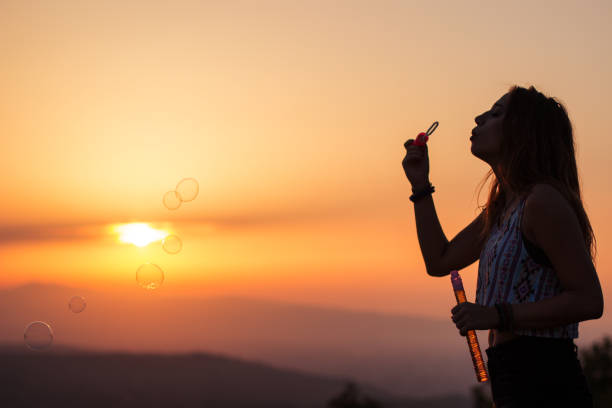 istock Young beautiful girl blowing bubbles 835888664