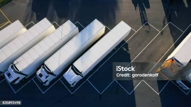 Aerial Top View Of White Semi Truck With Cargo Trailer Parking With Other Vehicles On Special Parking Lot Stock Photo - Download Image Now