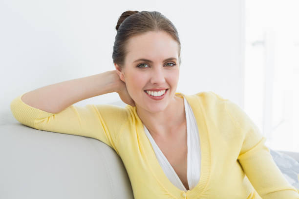 istock Smiling relaxed woman sitting on sofa at home 835892578