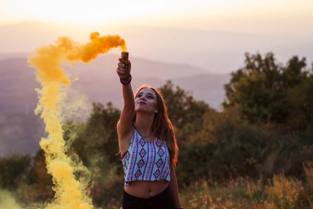 istock Girl in a yellow smoke cloud 835896176
