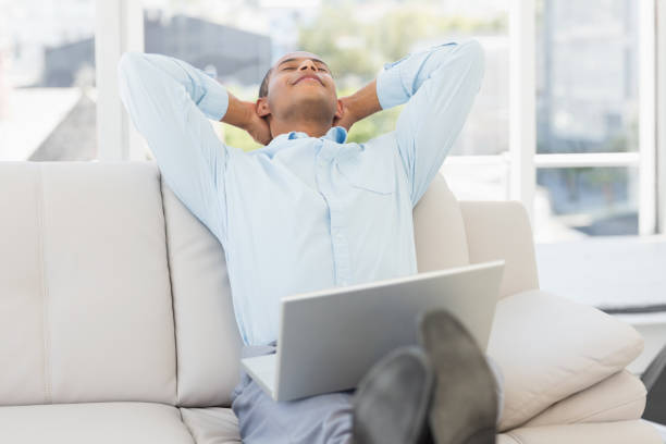 istock Relaxed businessman on the couch with laptop 835896404