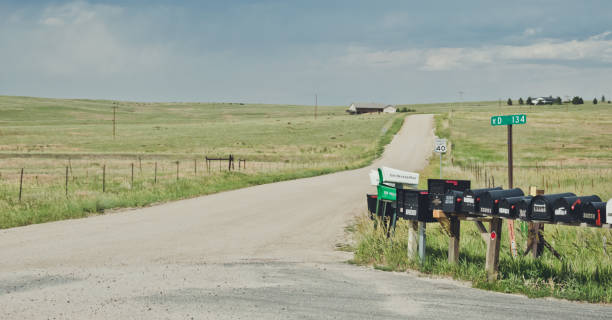 Old mailboxes on the rural road in Arizona. Old abandoned farm Bedrock City, Arizona, USA - June 20, 2017: village dirt road and the rustic old wooden mailboxes. Outskirts of an old farm in Arizona. Rural life in the USA. Obsolete communication system mailbox photos stock pictures, royalty-free photos & images