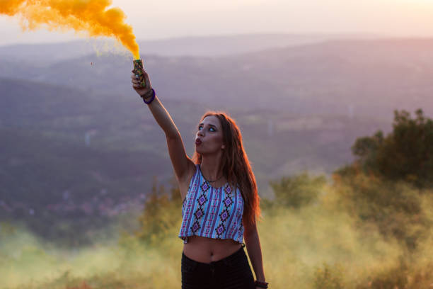 istock Girl in a yellow smoke cloud 835896996