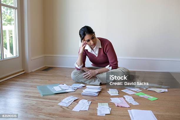 Woman Looking At Bills And Receipts On Floor Stock Photo - Download Image Now - Debt, Financial Bill, Tax