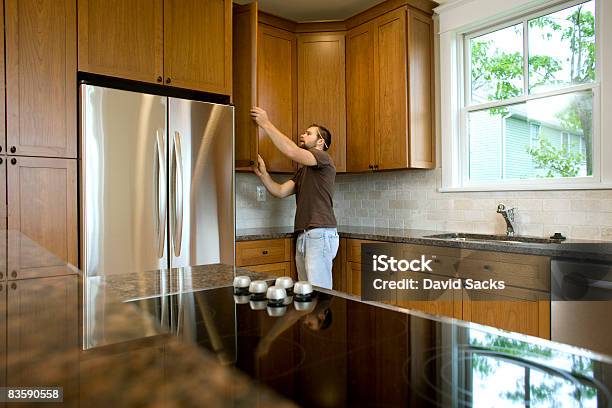 Contractor Working On Cabinets In New Home Stock Photo - Download Image Now - Examining, Domestic Life, Quality Control