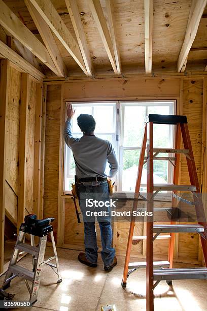 Contractor Working On Window In New Home Stock Photo - Download Image Now - Construction Industry, Domestic Life, Home Interior