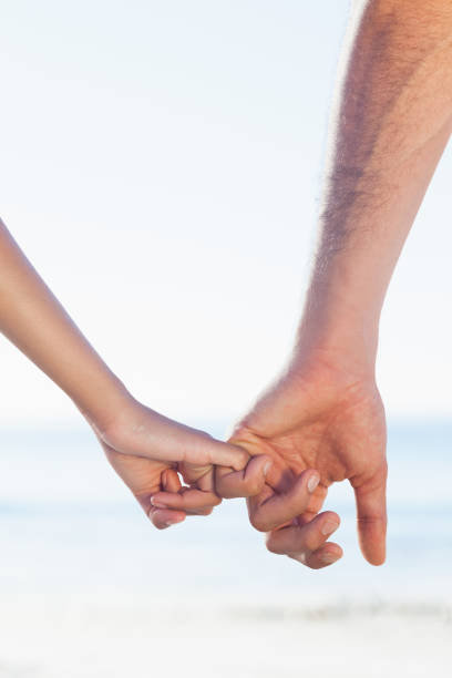 istock Loving young couple holding hands 835909262