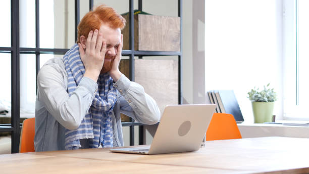 istock Beard Man Reacting to Loss while Working on Laptop 835909456