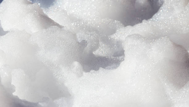 istock White soap foam on the beach as background 835909808