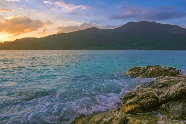 istock Splash waves hit rocks with the beautiful sunlight and sky . 835919382