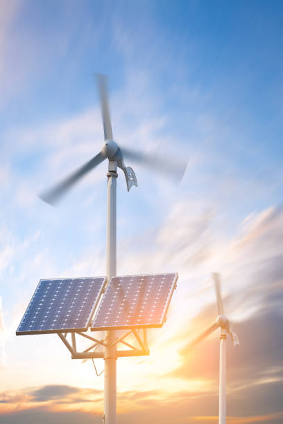 solar panels and wind turbines against city on background under blue sky. Header for website