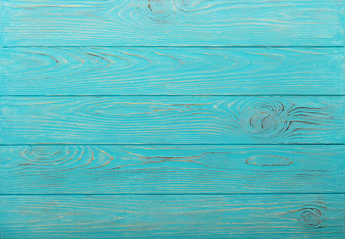 Wooden aged background of azure color. Selective focus.