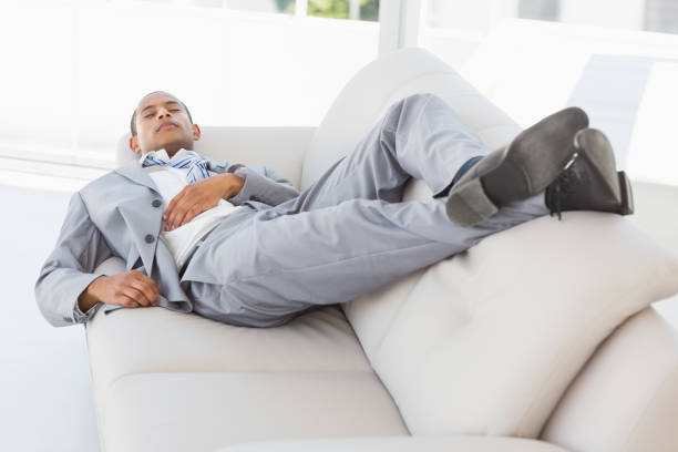 istock Businessman napping on the couch 835923294