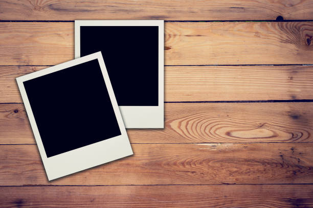 istock Old blank frame photo on wood background and texture 835925768