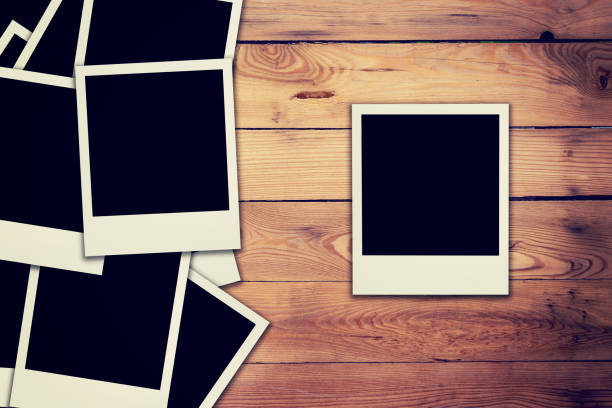 istock Old blank frame photo on wood background and texture 835925876