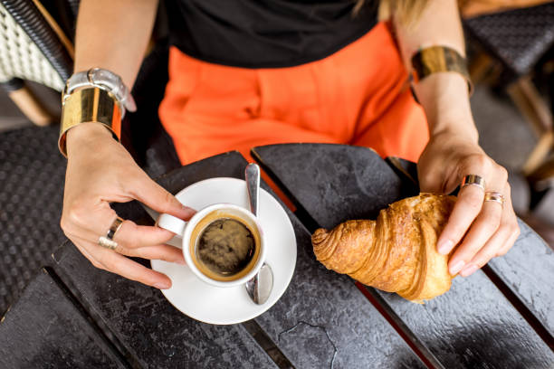 istock Holding coffee and croiisant 835925960