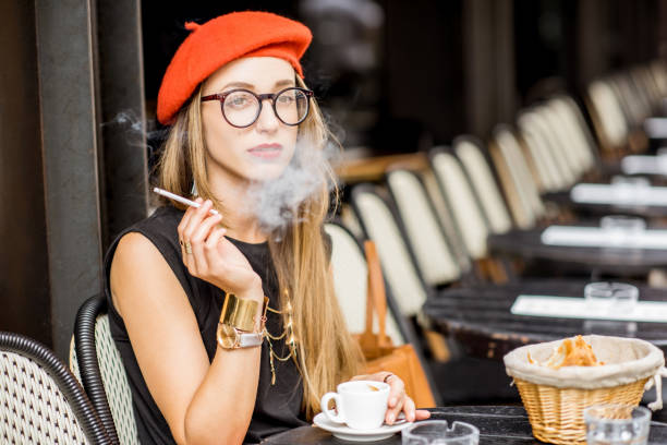 istock French woman smoking at the cafe 835926138