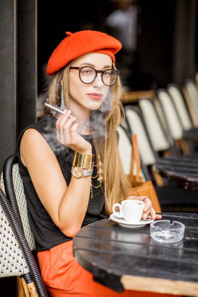 istock French woman smoking at the cafe 835926172