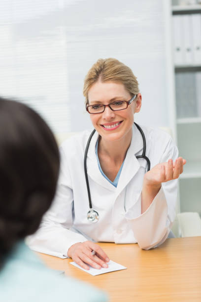 istock Smiling doctor listening to her patient 835926254